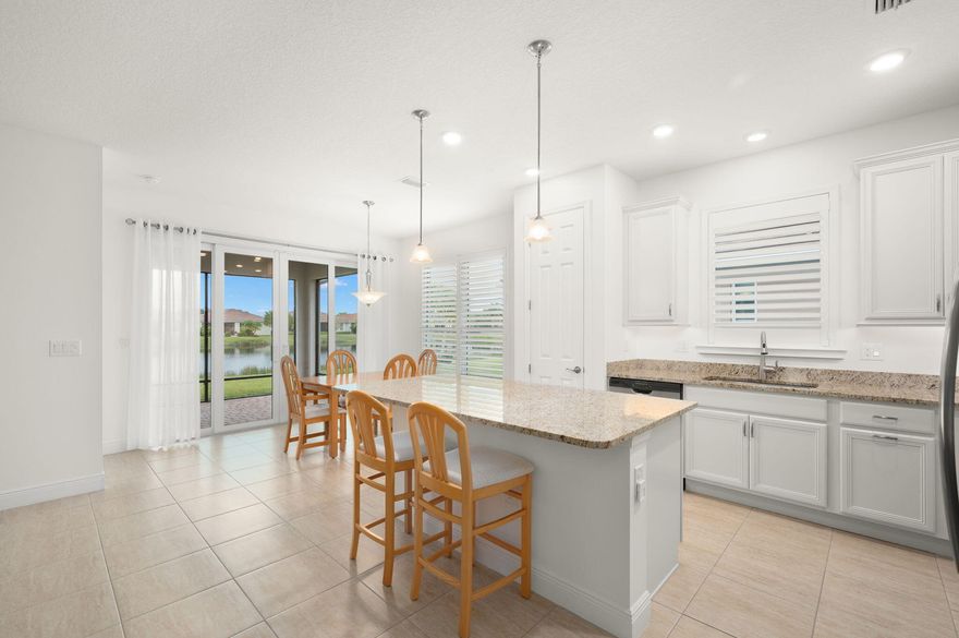 Central vacuum, tray ceilings, porcelain tile floors throughout, guest bath shower pan, wood plantation shutters, quality cabinets, kitchen undercabinet lighting, drawers in kitchen island/master bedroom vanity, laundry room cabinets, custom ventilated wood closet organizers, 4 ceiling fans including master bath, HVAC UV light, prime lake lot, tile roof, beautiful front door glass, impact windows/doors, whole house gutters, screened patio with 10-ft. sliding glass door/pavers, sloped front entry, 4-ft. extended garage with epoxy floor/attic stairs. The home is close to Vitalia's Clubhouse with a mailbox at the driveway. The owners prepaid the Tradition Bond, which is a tax savings to the buyer of $716/year through November 2034 ($6,444 total savings over the next 9 years). The home has Termite Protection Warranty until January 31, 2027, and HVAC Maintenance Protection until March 1, 2027; both services are transferrable to the new owner. The microwave and gas water heater were purchased new in 2024. The house exterior was painted in February 2026. Additional features include frameless shower enclosures, soft close cabinet drawers/doors, and decora light switches.