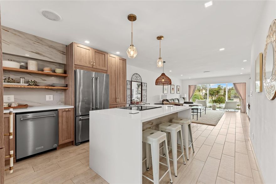 Imagine stunning floor-to-ceiling panoramic water views the moment you step into your new home. This beautifully renovated second-floor corner unit offers an open, light-filled floor plan and a modern kitchen designed for both style and functionality, complete with an in-unit washer and dryer. Enjoy direct ocean access from your private 20-foot deeded dock — with no fixed bridges to the ocean. The primary suite captures serene waterfront views and features a custom walk-in closet with built-ins and a beautifully updated en-suite bath. Impact windows and doors throughout provide peace of mind, while the tranquil setting creates the perfect second home or everyday retreat from the chaos of life.