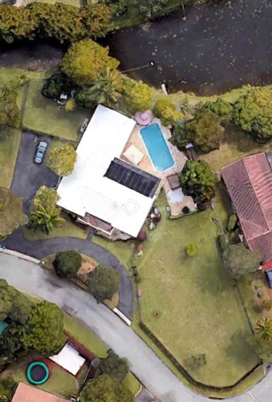 Impeccable 5 bedroom with 3.5 bathroom. Front facing North located on a huge corner lot with a gorgeous lake view!!!  Located in desirable Coral Springs.  Don't pass this amazing opportunity to own this much land in Broward County!!  Open floor plan with updated flooring, hurricane impacted windows with plantation shutters!!.  Large pool/spa area that looks out on the large yard with Gazebos and swings great for relaxing!  NO HOA!!!