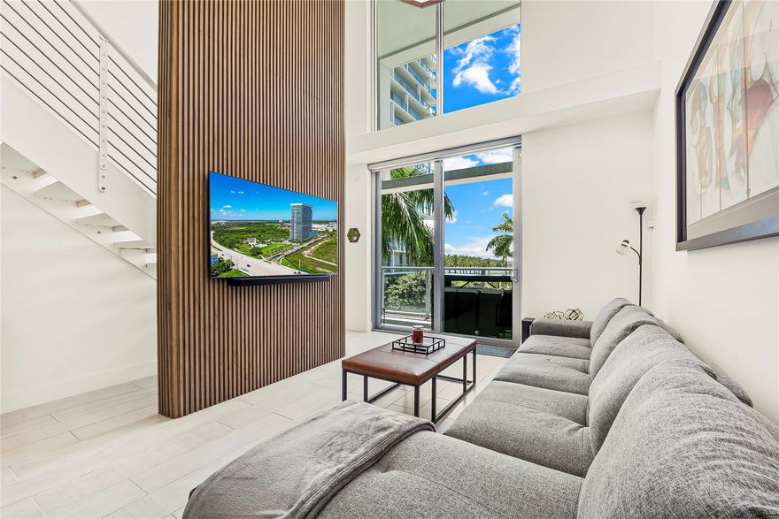 Luxury living just steps from the Panthers Hockey Arena and Sawgrass Mills Outlet Mall, where you can enjoy world-class shopping and dining. This stunning loft-style 2-bedroom + den unit offers breathtaking sunset lake views from every room. The building features top-of-the-line amenities, including a movie theater, gym, spa, pilates studio, and more. Experience effortless living in the peaceful suburb of Sunrise while staying just moments from all the excitement.