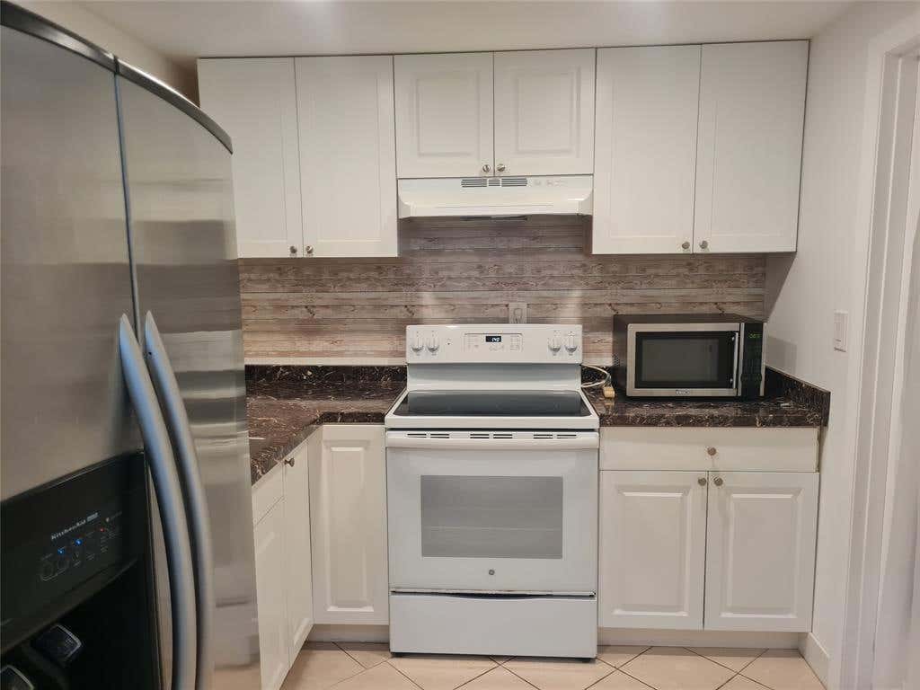 Photo of 300 Golden Isles Drive #104, Hallandale Beach, FL 33009 (MLS # B26062558)