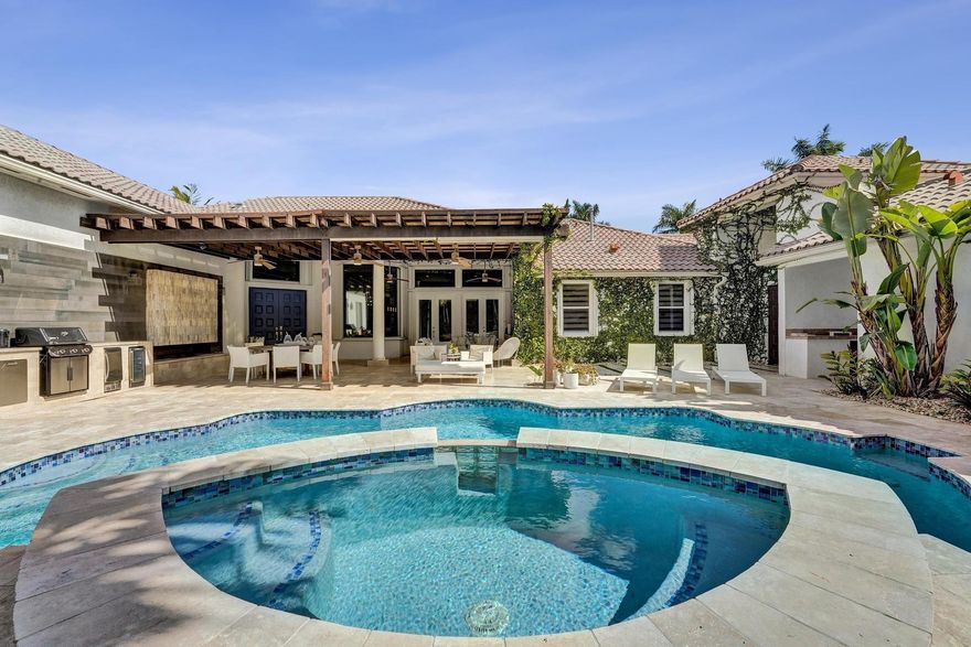 Very rare extended Courtyard Model with an expanded freestanding guest suite and built-in office. 4 bedrooms 4 1/2 baths with all bedrooms having en-suite bath.  Home features include a stunning master bedroom with large sitting area, double ovens, crown molding, custom drapes, decorative wine storage wall, central vac, marble floors throughout, accordion hurricane shutters and more beautiful upgrades. Enjoy outdoor luxury with a covered patio, stunning heated pool with spa waterfall, sport court built in grill. This is a unique opportunity to own an upgraded and rare floorplan in the falls with access to a plethora of community amenities.  Property is designer decorated with furniture negotiable.