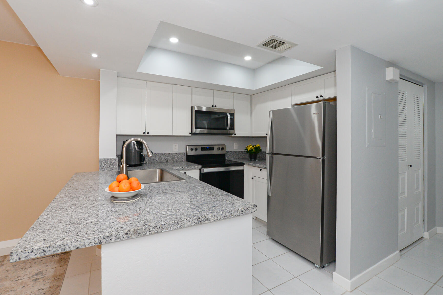 Beautifully updated and spacious 2-bedroom, 2-bathroom second-floor condo offering comfort, style, and a prime location. Enjoy the open-concept living and dining areas, perfect for entertaining or relaxing. The modern kitchen features granite countertops, new cabinets, stainless steel appliances, and a sleek gooseneck faucet. Both bathrooms have been fully remodeled with stylish, contemporary finishes. Additional features include brand-new tile flooring throughout, a screened-in balcony, accordion hurricane shutters, a 2024 AC system, and a 2023 water heater. The primary bedroom offers a double-door entry and ample space for a peaceful retreat. Ideally located just minutes from Route 1, with convenient access to the hospital, shopping, and restaurants. A move-in ready gem.