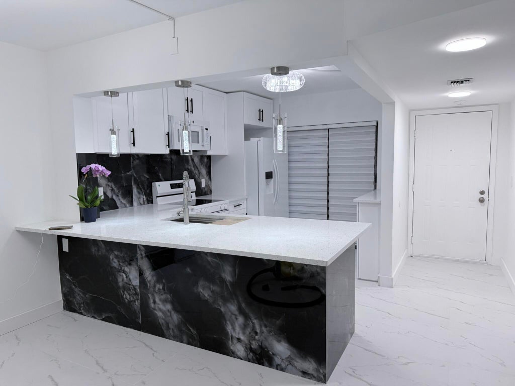 Photo of 300 E Club Circle #107, Boca Raton, FL 33431 (MLS # B26044168)
