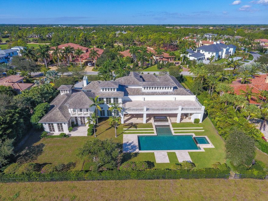 STUNNINGLY DESIGNED TWO STORY HOME ON A PREMIUM LOT LOCATED DIRECTLY ON THE GOLF COURSE AND LAKE IN THE CUSTOM ESTATE SECTION OF OLD PALM. BEAUTIFULLY APPOINTED FINISHES THROUGHOUT WITH 6 FULL BEDROOMS AND 8 FULL BATHS. ONE OF THE LARGEST PRIVATE POOLS AND EXQUISITE LOGGIA AREA WITH FIRE PIT AND SUMMER KITCHEN. ABUNDANCE OF NATURAL LIGHT WITH FLOOR TO CEILING WINDOWS AND SLIDERS. CUSTOMIZED CLUB ROOM WITH THEATER AND FULL BAR. MAGNIFICENT MASTER SUITE ACCENTED WITH REFLECTION POND AND LIBRARY WITH CUSTOM BUILT INS AND PATIO. KITCHEN IS ACCENTED WITH EXPANSIVE BREAKFAST BAR AND ALL THE UPGRADES YOU EXPECT FOR LUXURY LIVING IN OLD PALM. OLD PALM HAS A RAYMOND FLOYD DESIGNED CHAMPIONSHIP COURSE WITH WORLD CLASS PRACTICE FACILITIES.