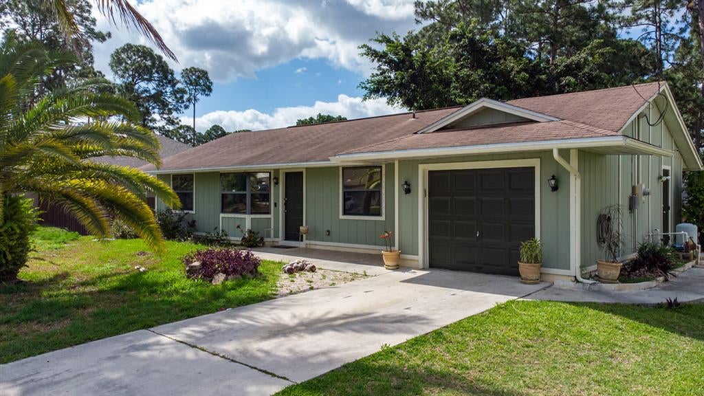 Photo of 1668 SW Mackey Avenue Avenue, Port Saint Lucie, FL 34953 (MLS # R10711883)