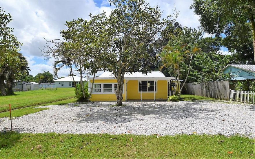 Discover this Key West style home bursting with charm, character & unbeatable curb appeal...all in one of Palm City's most sought after locations with no homeowners association! Lovingly maintained, this residence features a brand new metal roof, updated electrical & plumbing fixtures and numerous renovations over the years including newer kitchen, baths, appliances & windows. Spectacular yard surrounded by lush landscaping for privacy. City water and county to provide sewer in the future at no cost. County has excavated for excellent drainage. Best value in Palm City with no HOA.