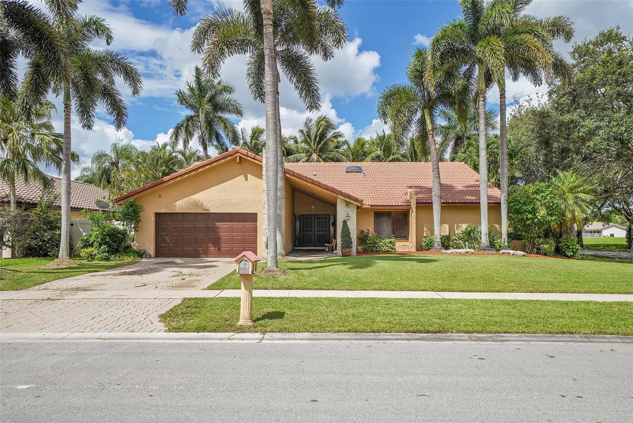 Run to this beautiful gem in the newer section of Jacaranda Lakes. This home is located on a corner lot with gorgeous lake views. It features a newly renovated kitchen with quartz countertops, newer appliances, a duel zone wine color for both red and white wines, travertine marble floors, hurricane protected skylights in the kitchen and bathrooms, newer fireplace, custom wood panels in dining room, Plantation shutters in kitchen, garage tech with cabinets, tiki hut, inground pool within waterfall decent and fiber optic lighting that changes color, artificial grass, and more. Hurry this amazing home has it all!