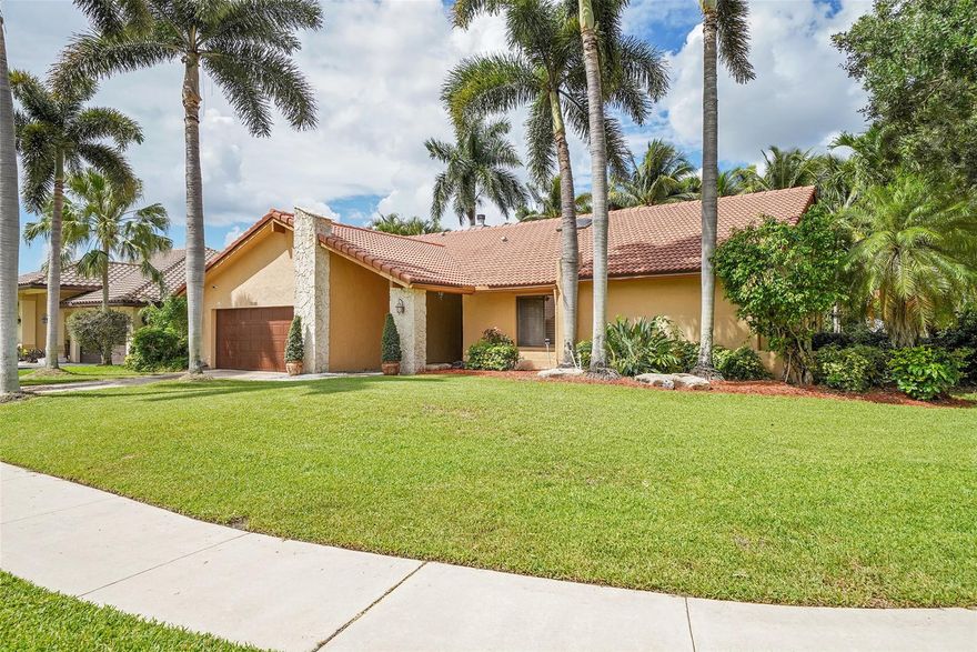 Run to this beautiful gem in the newer section of  Jacaranda Lakes. This home is located on a corner lot with gorgeous lake views. It features a newly renovated kitchen with quartz countertops, newer appliances, a dual zone wine color for both red and white wines, travertine marble floors, hurricane protected skylights in the kitchen and bathrooms, newer fireplace, custom wood panels in dining room, Plantation shutters in kitchen, garage tech with cabinets, tiki hut, inground pool within waterfall decent and fiber optic lighting that changes color, artificial grass, and more. Hurry this amazing home has it all! Recently price improved to recent sale comps...