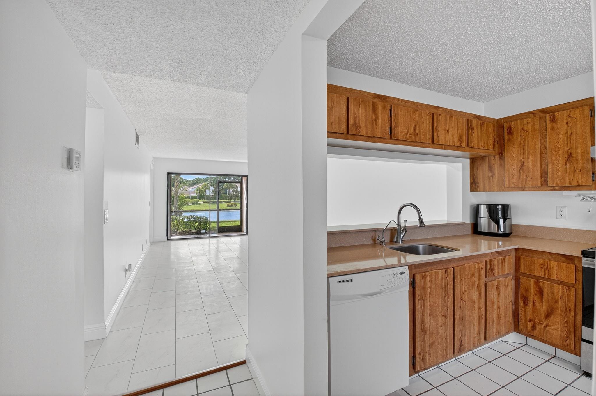 Lakefront 2BR/2BA condo in central Boca Raton. Features include vaulted ceilings, split bedroom floor plan, walk-in closet in primary suite, and 2 fully renovated bathrooms. Brand new A/C (2025). First floor unit with beautiful lake views. Quiet, well-maintained community with pool and car wash area. Excellent location—just 5 miles from the beach, close to Town Center Mall, dining, shopping, and parks.