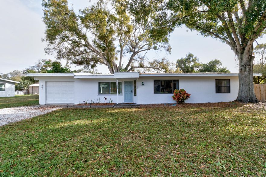 Charming mid-century 3 bedroom, 1bath home that thoughtfully blends modern updates with vintage character. 2021 METAL ROOF, terrazzo floors,updated kitchen- stainless steel appliances & butcher-block counters + completely renovated bathroom. Dedicated washer/dryer room, vaulted ceilings & custom impact front windows. Situated on a spacious fully fenced 0.39acre (double lot-may add ADU) with mature oaks, back patio for outdoor enjoyment & plenty of room for your toys. Near Downtown Vero offering easy access to restaurants & more. Converted garage= LARGE 3rd bedroom or flex room. No sign in yard Garage converted to 3rd LARGE bedroom or can be used as bonus room. DOUBLE LOT MAY ADD GUEST HOUSE UP TO 50% of primary house (Buyer to verify with county)