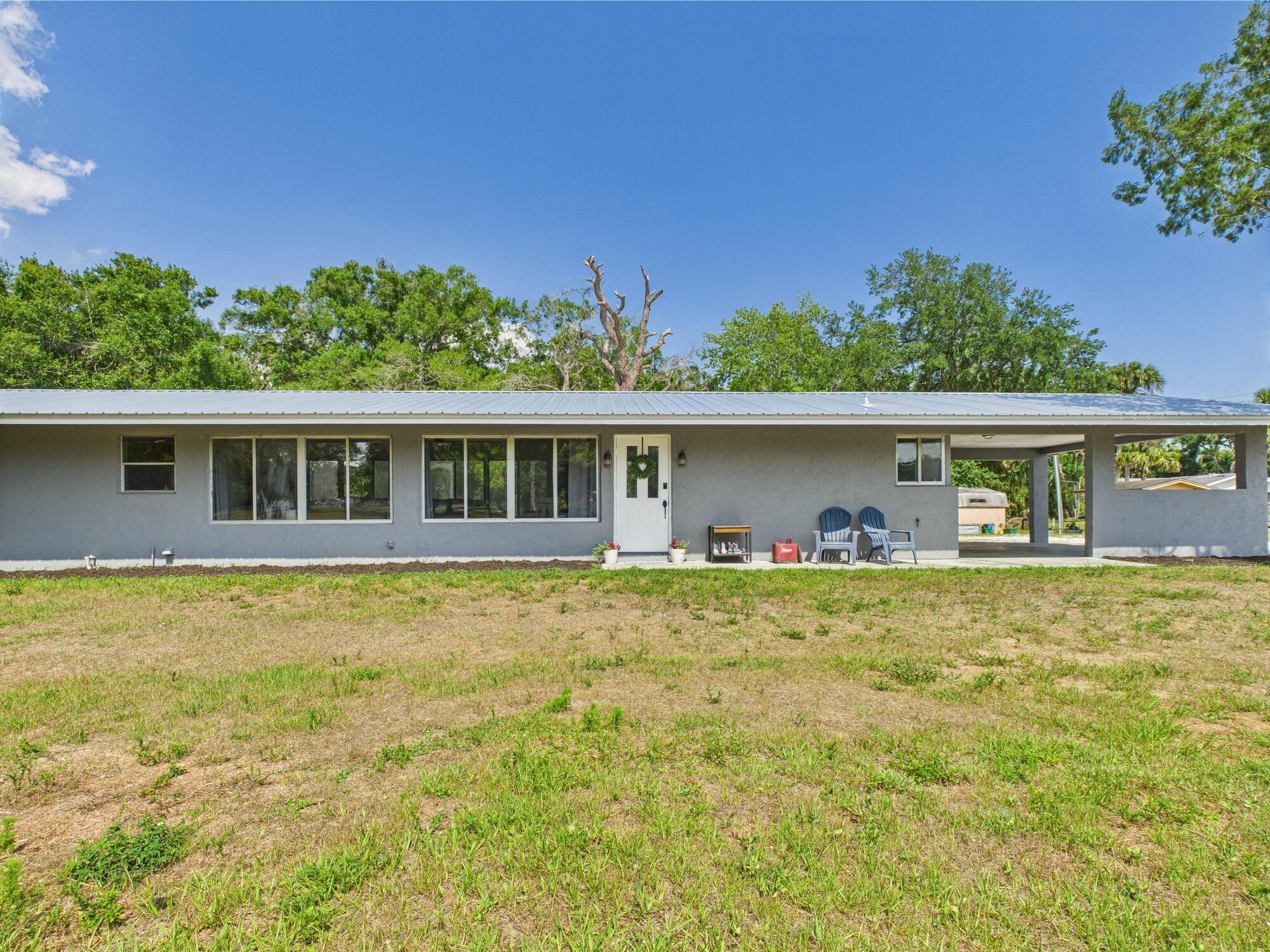~BACK ON MARKET~INSPECTED AND APPRAISED *5 ACERS* Rustic charm meets modern updates in this fully remodeled 3BD/2BA home on 5 acres. A brand-new metal roof, gorgeous new kitchen, and walls of windows fill the home with natural light. Set back off the road, it features a long gravel drive, open carport, and U-shaped layout with a huge patio at its heart. Enjoy a shady oak hammock out front, a pond by the house, and a creek winding through untouched Florida woods out back. Room for all your animals, toys, and even your RV. 3-D and floorplan will be available shortly