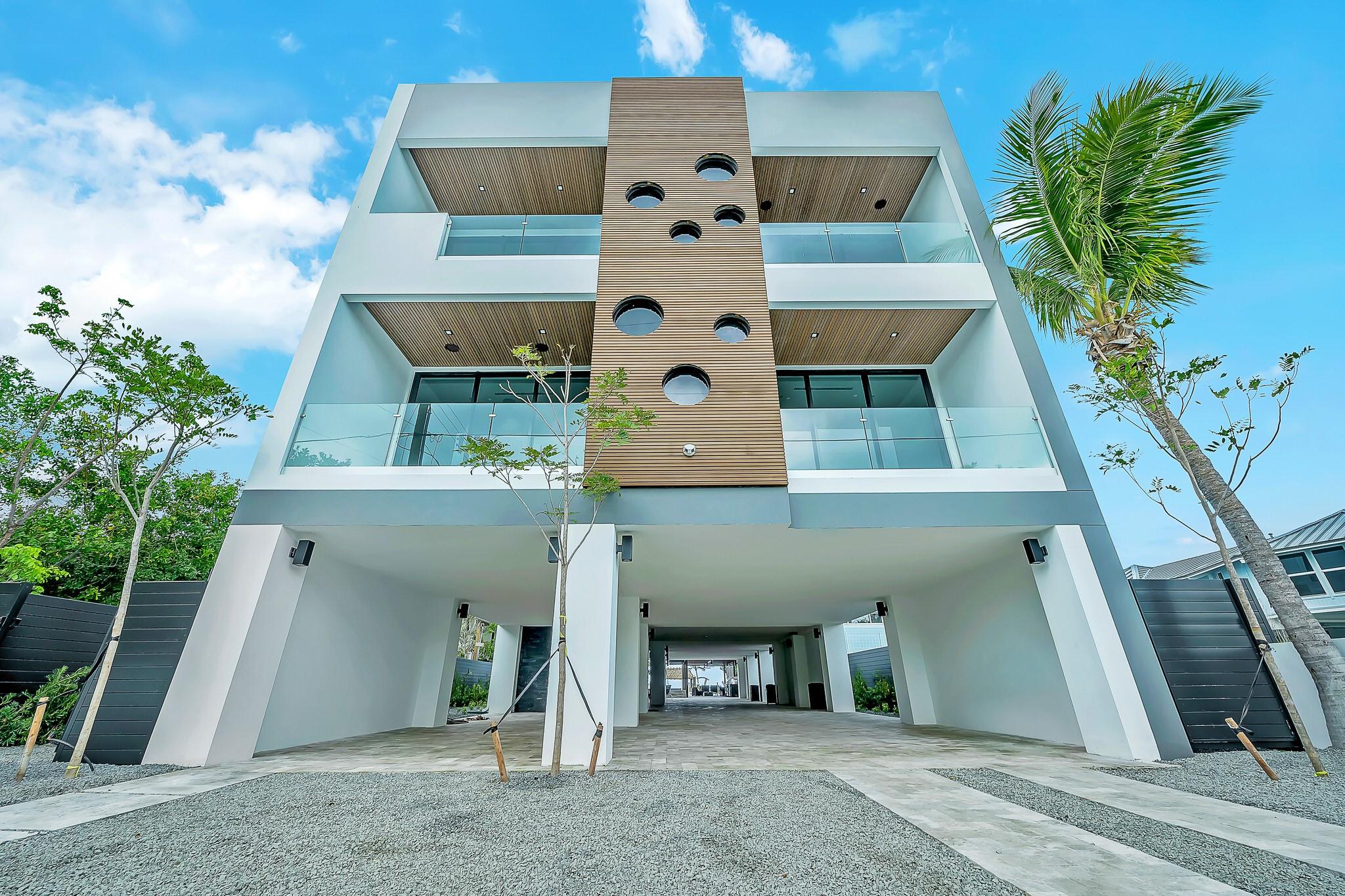 This property is an exquisite example of modern ocean side living in the Florida Keys with 7 bedrooms, 7 in suite bathrooms, 2 half baths, whole smart home technology for lights, security and sound all the way to the beach, custom chef kitchen, whole home generator, 4 zone cooling, elevator, custom wine cellar, and primary bedrooms on 2 floors. Outside you have an outside kitchen, extended covered seating, pool with spa and waterfall off the pergola, private lagoon with parking for five boats each with water and shore power, boat lift, custom fish station, private beach with tiki hut, approximately 2,500 sq feet of covered parking and smart home controlled LED lighting.