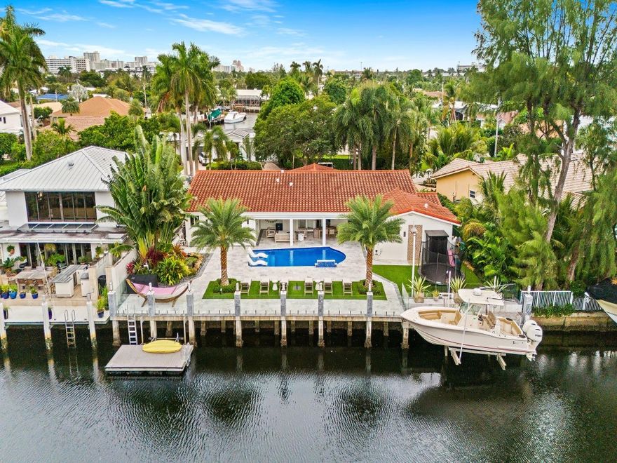 Located in the prestigious Landings neighborhood of Fort Lauderdale, this turnkey 4 bedroom + office, waterfront residence offers the perfect blend of comfort, security, and South Florida lifestyle. Featuring a 2021 roof, all-impact windows, PVC plumbing throughout, and a full-home generator, the property is built for peace of mind. Enjoy Sonos audio throughout, exterior security cameras, power screens and shutters on the patio, a heated saltwater pool, a tranquil koi pond, and a brand-new elevated concrete seawall with sleek glass barrier. Boaters will appreciate the 14,000-lb boat lift and floating dock platform ideal for paddleboards and kayaks, while an outdoor sauna creates a private wellness retreat. A rare opportunity in one of Fort Lauderdale’s most desirable communities.