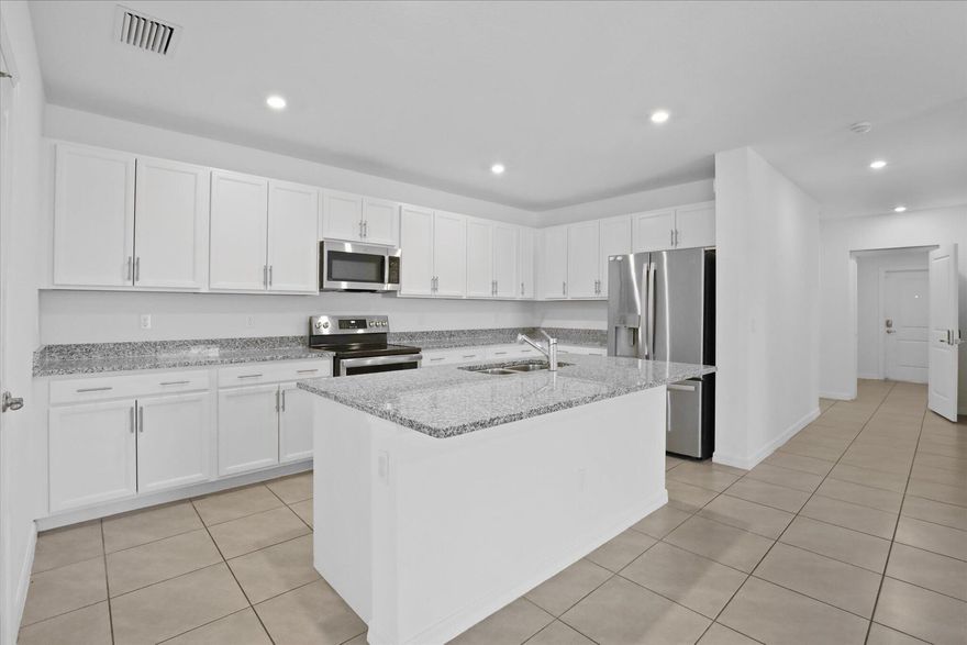 Nearly new 2023-built home with a rare flexible-living layout you won't easily find nearby. This move-in-ready property features a private flex suite perfect for multigenerational living, a quiet home office, guest space, gym, or creative studio. Located on a desirable corner lot with no HOA, this home offers modern finishes, an open-concept layout, split-bedroom design, and the peace of mind of newer construction. Conveniently located near shopping, dining, schools, and major highways. A versatile, low-maintenance home that stands out from typical Port St. Lucie inventory. Listing agent is related to owners. All measurements are estimates buyers/agents to verify.