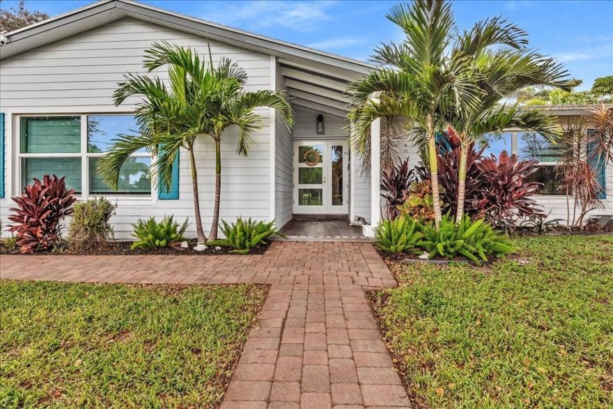 Tropical Oasis in DAVIE on a builder's ACRE! This updated 5/3 home has IMPACT WINDOWS, vaulted ceilings exposed wood beam ceilings, brand NEW KITCHEN with waterfall marble countertops, SS appliances, with so much cabinet storage.  If you like to cook, and entertain, this is the kitchen for you. The open layout flows to a stunning travertine patio and sparkling POOL that overlooks a PRIVATE POND stocked with fish and turtles. As a unique bonus, the home has an adorable IN-LAW SUITE equipped with a full kitchen!   It's like being on vacation every day. EV CHARGER already in place.  Enjoy a spa like primary suite, cabana bath and space for you BOAT or RV.  NO HOA to apply for.  EASY QUICK APPLICATION PROCESS. Just minutes from top-rated schools, parks, and highways.