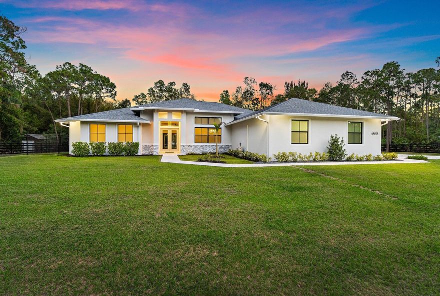 GORGEOUS and GRAND Brand New Home on Picture Perfect 1.16 Acre lot, tranquil + fully privacy fenced.  This MOVE-IN-READY Modern ranch  home offers over 4,220 Impeccable sq. ft. on one level.  Modern Country design elements include wood grain tile floors, Impact windows + doors throughout, volume ceilings and a spacious kitchen with tons of storage. Exceptional floor plan offers generous living area and a spacious Primary suite, private + serene.  4 additional guest rooms include an in-law suite with separate entrance. Important after build upgrades include custom closets + walk in pantry, new lighting + window treatments, new gutters + downspouts, new audio, televisions + cameras and epoxy garage flooring.  Picturesque + convenient location just one lot north of Randolph Siding on a quiet  road. This 1.16 acre parcel allows plenty of space to add a pool, detached garage or guest house. Tremendous value per sq. ft for a Brand New Beautiful home!  Enjoy the beauty of Country living along with the conveniences of Jupiter life:  A short drive to Best schools, shopping, dining and ocean beaches.  Easy access to PB Int'l airport as well as North County private airport.  Truly a fabulous place to live and enjoy!