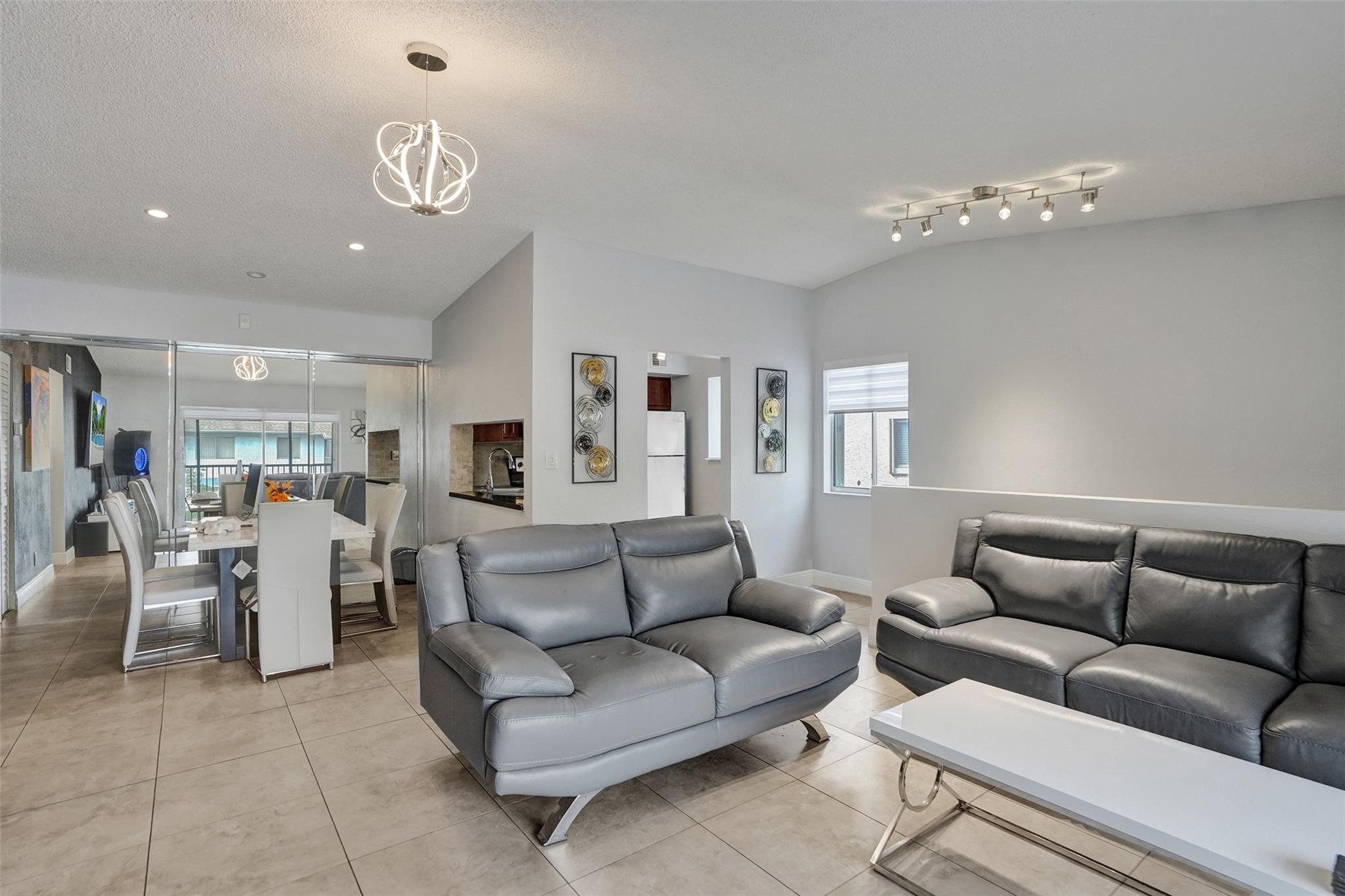 This 2-bedroom, 2-bath second-floor corner unit offers light and style with vaulted ceilings and porcelain tile floors in the main living area. Kitchen features stainless steel appliances. Full-size front-loading washer and dryer in-unit add convenience. Brand-new Water Heater, newer A/C, Accordion Shutters, and completed 40-year certification with reserves in the budget. The bedrooms have ceramic tile floors, and the primary suite includes a walk-in closet. Relax on the screened balcony with extra storage closet. Pet-friendly community (up to 50 lbs) with pool, clubhouse, and scenic lakes. Prime location near I-95, Chase Stadium, shopping, and dining. Can lease after 2 years of ownership. No current or proposed special assessments! LOW DOWN PAYMENT POSSIBLE!
