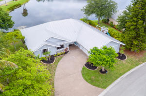 Look no further! This lakefront beauty is located in the highly desirable Jupiter Narrows community and has been completely renovated. Featuring 3 bedrooms, 2 baths, and a 2 car garage, this coastal home is biking distance to the beautiful Hobe Sound beaches. Complete with a metal roof, engineered hand scraped wood flooring throughout the living areas, 5-1/2'' baseboards, new light fixtures (Pottery Barn & Restoration Hardware) LED High hats in kitchen and master bathroom, LED outside lighting, two 72'' fans in living room, reclaimed barnwood wet bar with custom cabinetry, undermount sink, marble top, Kohler Karbon wall mount faucet, wine fridge and LED lighting.