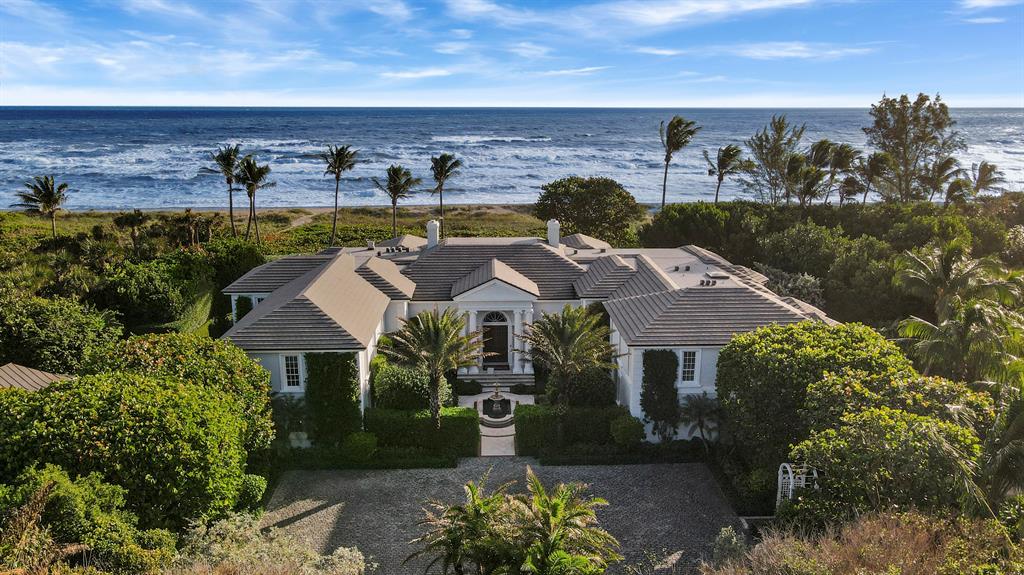 Located on prestigious Jupiter Island, this breathtaking property spans nearly 2.5 acres with an astounding 255 feet of direct ocean frontage. Recent renovations bring a delightfully new, bright and open feel to this spacious 2 story residence. Over 10,000 sq. ft. includes an open chef inspired gourmet kitchen, custom wine cellar, private elevator, six bedroom split floorplan providing maximum privacy for your master retreat, while providing guests with 5 star accommodations. Numerous rooms including a state of the art theater, will entertain and accommodate many family members and guests. Lush landscaping creates a complete private and secluded outdoor entertainment paradise. This property is sure to impress even the most discriminating of buyers