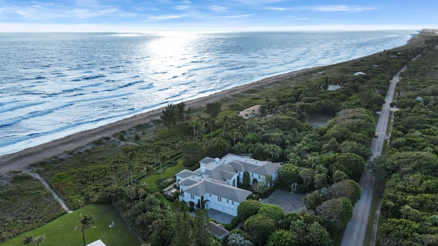 Located on prestigious Jupiter Island, this breathtaking property spans nearly 2.5 acres with an astounding 255 feet of direct ocean frontage. Recent renovations bring a delightfully new, bright and open feel to this spacious 2 story residence. Over 10,000 sq. ft. includes an open chef inspired gourmet kitchen, custom wine cellar, private elevator, six bedroom split floorplan providing maximum privacy for your master retreat, while providing guests with 5 star accommodations. Numerous rooms including a state of the art theater, will entertain and accommodate many family members and guests. Lush landscaping creates a complete private and secluded outdoor entertainment paradise. This property is sure to impress even the most discriminating of buyers