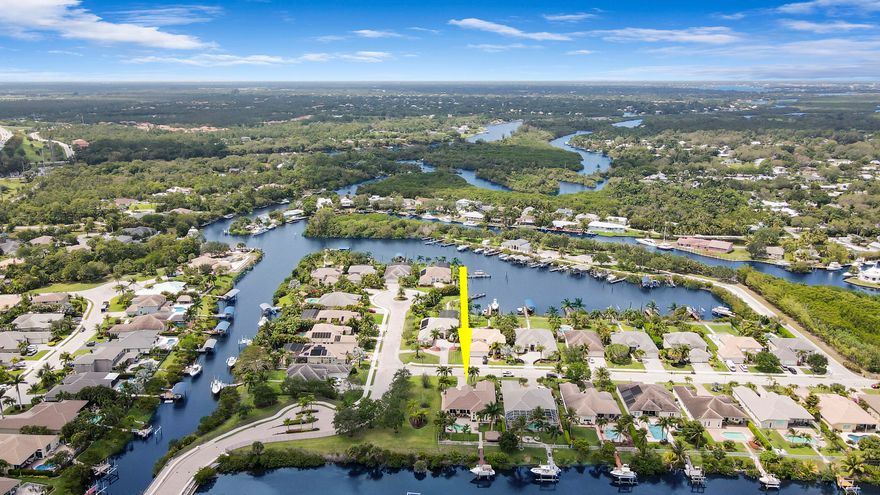 Come see this impressive waterfront pool home located in a gated boating community. This 4 bedroom (plus den/office), 3 bath home is on a deep-water canal with a dock (updated in 2020) and a 13K lift located behind the home with ocean access and no fixed bridges. Great outdoor living with a fenced backyard with an awesome heated saltwater pool and a Tiki Hut with a built-in outdoor style kitchen, lush landscaping and on a corner-lot add to a private setting. The interior of the home is nicely appointed with formal dining and living room and a large combo kitchen and family room. The kitchen was recently renovated with white quartz countertops, new custom cabinetry for ample storage and white tile backsplash.  Large 3 bay garage allows for good storage. Both A/C units replaced in 2023. Who le house Generac 22kw generator installed in 2020 and new water full filtration system with reverse osmosis. Easy access to I-95.