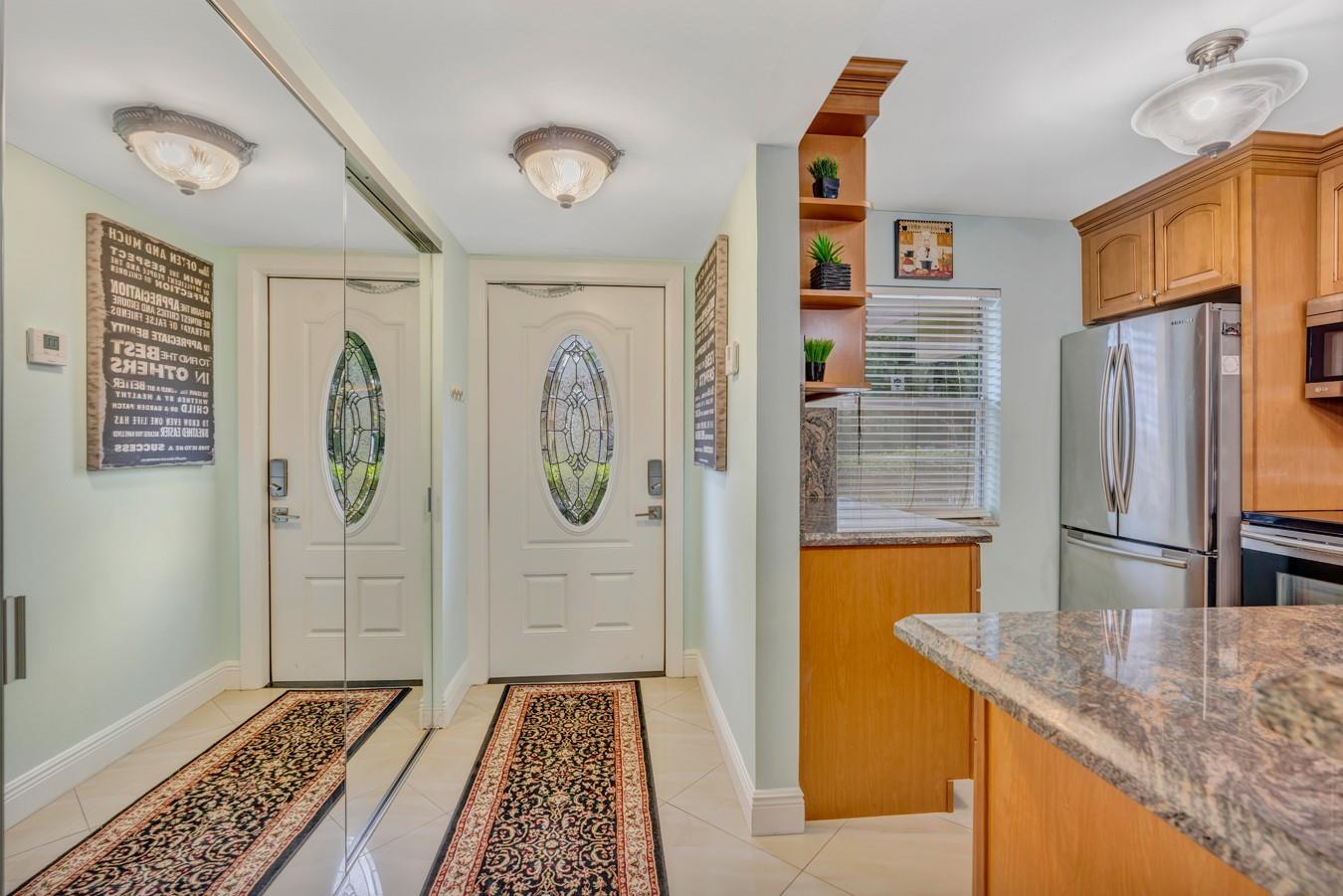 Welcome to your new oasis! This beautifully renovated 990 sq ft condo features 2 spacious bedrooms and 2 updated baths, including a primary ensuite with a separate shower and walk-in closet. Enjoy vinyl and tile flooring, a stylish kitchen with granite counters, stainless steel appliances, a breakfast bar, and butler’s pantry. Plantation shutters and elegant lighting add charm throughout. Relax on your private patio or explore community amenities: heated pool, BBQ area, gym, billiards, and more. With central A/C and heating, comfort meets convenience. Fantastic location close to shops, restaurants, transit, and just 20 minutes from the beach. Schedule your tour today!