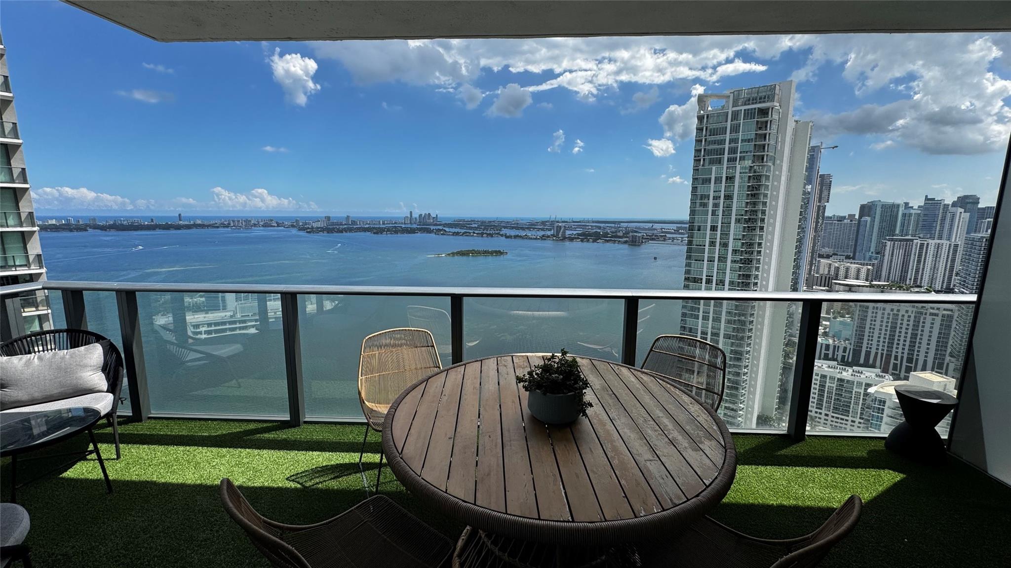 Breathtaking bay views from this corner residence! Wake up to spectacular sunrises over Biscayne Bay from your private balcony in this stunning, upgraded home at Paraiso Bay. This luxurious corner unit offers panoramic water and city views and over $200,000 in high-end upgrades, including a full smart-home system, automatic blinds, built-in ceiling speakers, and designer finishes throughout. Enjoy a seamless blend of technology, comfort, and style. Walk to the Miami Design District, Wynwood, fine dining, boutiques, and nightlife—this is truly urban resort living at its best. Includes garage parking space and access to world-class amenities. Experience the ultimate Miami lifestyle—walk everywhere and wake up to paradise every day!