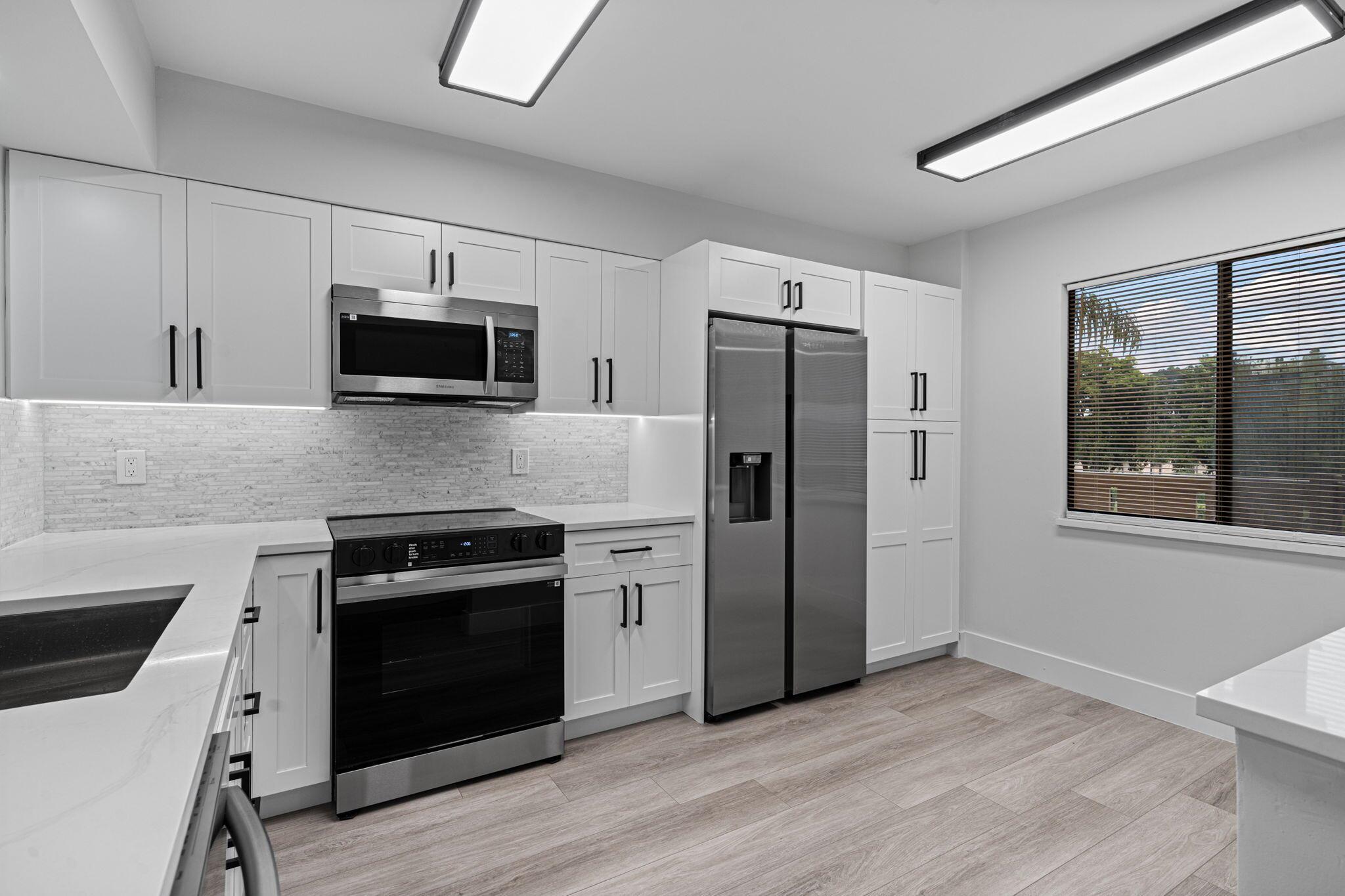 Step into luxury in this fully remodeled 2-bed, 2-bath corner condo unit in the highly sought-after 55+ community of Huntington Lakes. This 1230 Sq Ft unit is the best value money can buy in all of Huntington Lakes. Enjoy breathtaking lake views from your private balcony in a safe, vibrant, and amenity-rich neighborhood. This unit features 100% waterproof simulated wood throughout, brand-new stainless-steel appliances, quartz countertops, custom lighting with hi-hats throughout, and modern LED mirrors in both bathrooms. Popcorn ceilings were professionally removed throughout. Huntington Lakes offers a newly renovated clubhouse, 24/7 manned gate, pickleball and tennis courts, a fitness center, and endless social activities. Resort-style living in Delray Beach awaits!