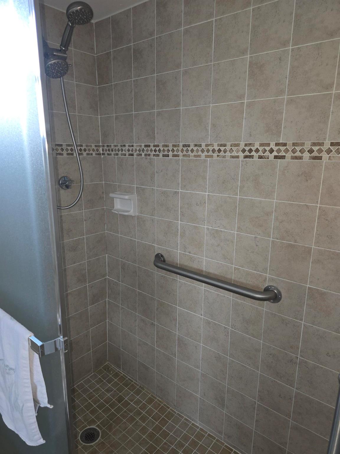 Step into this bright and inviting corner unit located in the heart of Lake Worth! This convertible model offers the versatility to create a full two-bedroom layout by simply adding a wall and door, featuring a convenient Jack and Jill bathroom in between. The unit boasts updated features including a new shower enclosure, spacious living and dining areas, and large windows that fill the home with natural light. Enjoy your morning coffee or evening breeze from the screened balcony overlooking the lush, landscaped grounds.This top-floor condo is located in a well-maintained 55+ community offering resort-style amenities--heated pool, clubhouse, shuffleboard, and walking paths--all just minutes from shopping, dining, and beautiful Lake Worth Beach.