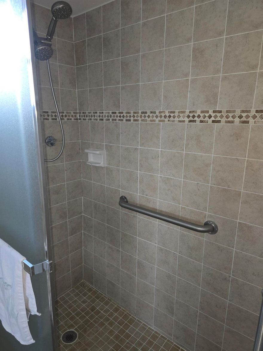 Step into this bright and inviting corner unit located in the heart of Lake Worth! This convertible model offers the versatility to create a full two-bedroom layout by simply adding a wall and door, featuring a convenient Jack and Jill bathroom in between. The unit boasts updated features including a new shower enclosure, spacious living and dining areas, and large windows that fill the home with natural light. Enjoy your morning coffee or evening breeze from the screened balcony overlooking the lush, landscaped grounds.This top-floor condo is located in a well-maintained 55+ community offering resort-style amenities--heated pool, clubhouse, shuffleboard, and walking paths--all just minutes from shopping, dining, and beautiful Lake Worth Beach.