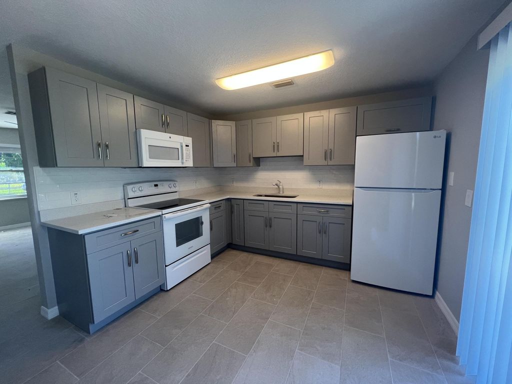 Photo of 1887 Breezy Lane, West Palm Beach, FL 33417 (MLS # B26045707)
