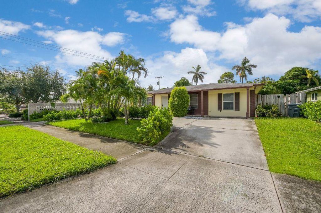 Photo of 118 E Ilex Drive, Lake Park, FL 33403 (MLS # R10649244)