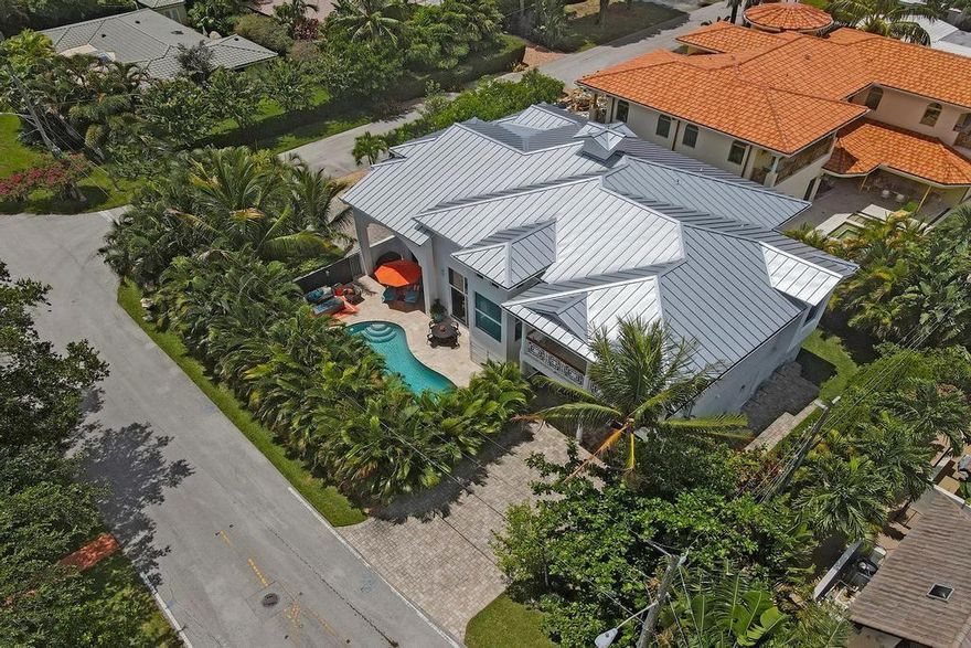 This is it! 10 out of 10! Everything you could wish for in a contemporary beach area pool home! Soaring 21' ceilings highlight spacious living areas and an amazing chef's kitchen with butler's pantry, double islands, European cabinetry, quartz counters and Viking appliances. Large impact windows and sliders open to the private tropical pool area with covered seating and spacious pool deck. 4 Full Bedrooms each with en suite, (two with patio or balcony) plus office and full cabana bath. Primary Suite features morning bar, balcony, two walk-in closets and a spa like bath with double vanity, stand alone tub and large walk-in shower.  Fantastic Dolphin Isles location between the ocean and the Intracoastal just minutes to the sand with direct access to Birch State Park. Bayview School District.