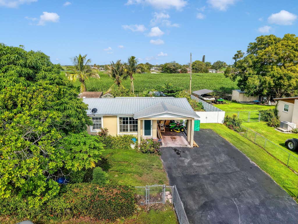 Photo of 1048 WHITAKER Road, Belle Glade, FL 33430 (MLS # B26059197)