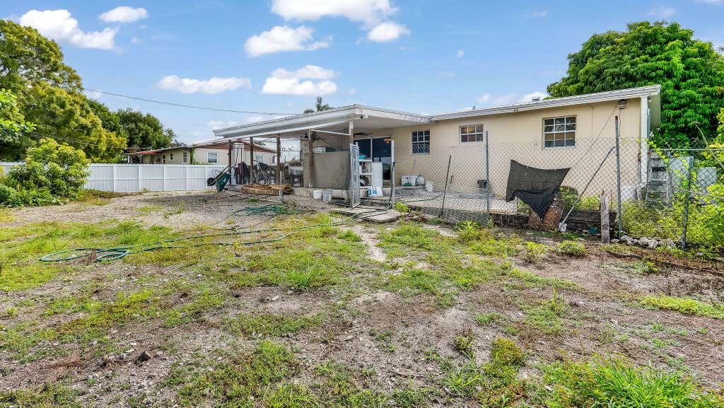 Photo of 1048 WHITAKER Road, Belle Glade, FL 33430 (MLS # B26059197)