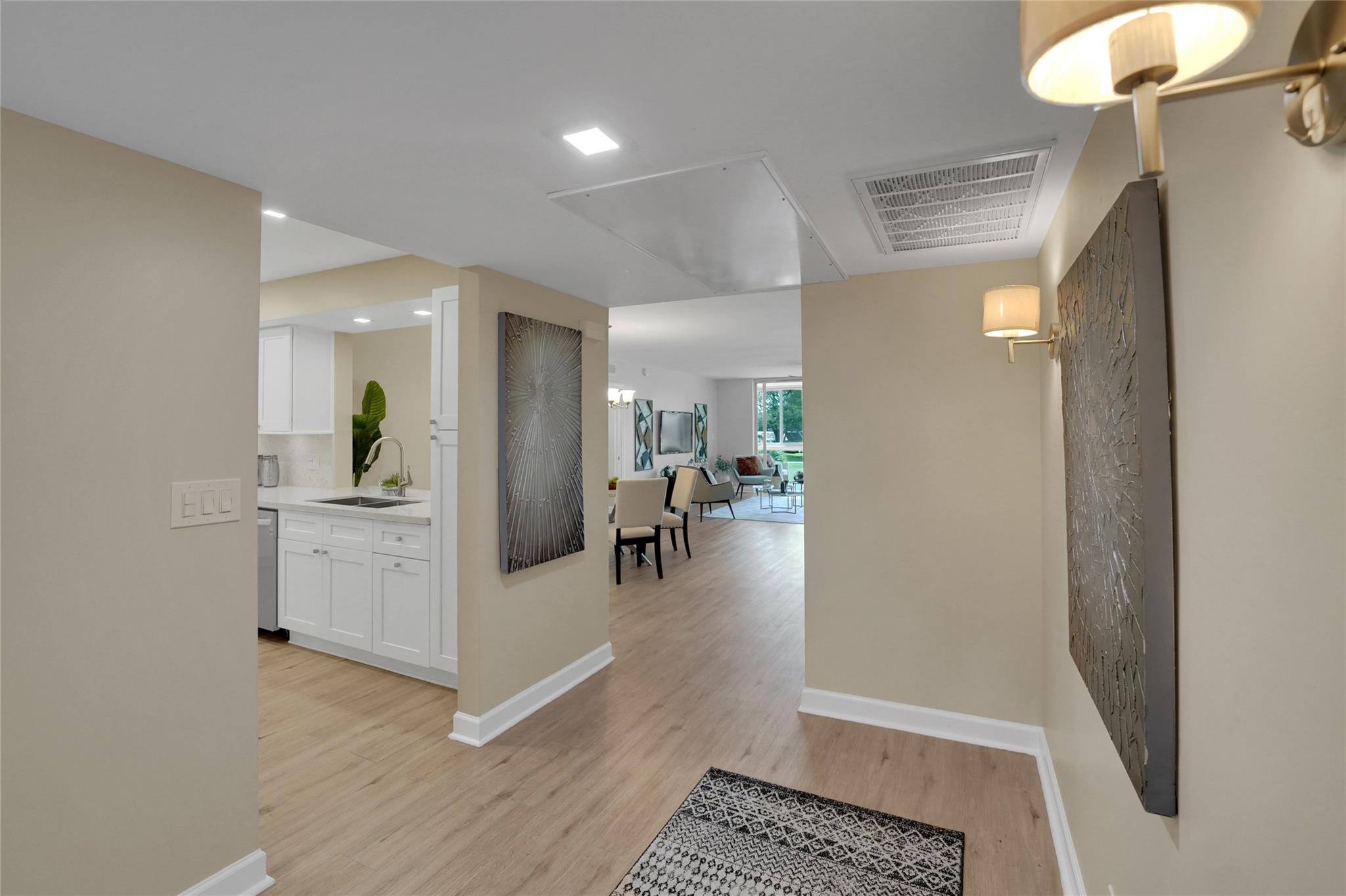 New on the Market! Palm Aire 3-Bedroom King, a fully remodeled residence that redefines luxury living. Over 2,000 sq. ft., this home boasts higher ceilings, impact glass windows throughout, and sweeping views of the lake and golf course. Floorplan is both functional and private, anchored by a separate primary suite with completely remodeled, windowed office. Both LR and primary have glass enclosed patios flooding the rooms with light. Kitchen shines with quartz countertops, recessed lighting, new appliances and custom touches, while subtle luxury flooring flows seamlessly throughout. Upgrades include relocated laundry center with built-in ironing board, spa-like primary bath with shower bench, and an automated Toto toilet. New roof, new A/C, a repaved driveway and close-up parking space.