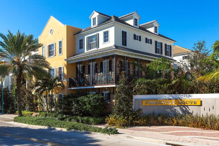 Located in the heart of Pineapple Grove Village, this beautifully upgraded townhouse in Cannery Row offers refined living in one of downtown Delray Beach's most desirable communities. The first floor includes a spacious two-car garage and a private en-suite bedroom with a bathtub ideal for guests or as a quiet home office, separated from the main living areas. A staircase with solid hardwood treads and risers leads to the second floor, where you'll find matching wood floors and a thoughtfully designed layout. The large eat-in kitchen features white Shaker-style cabinetry, light granite countertops, and an oversized island that functions as both a practical workspace and a central gathering spot. Opposite the powder room, a bright formal living room is framed by large windows, bright