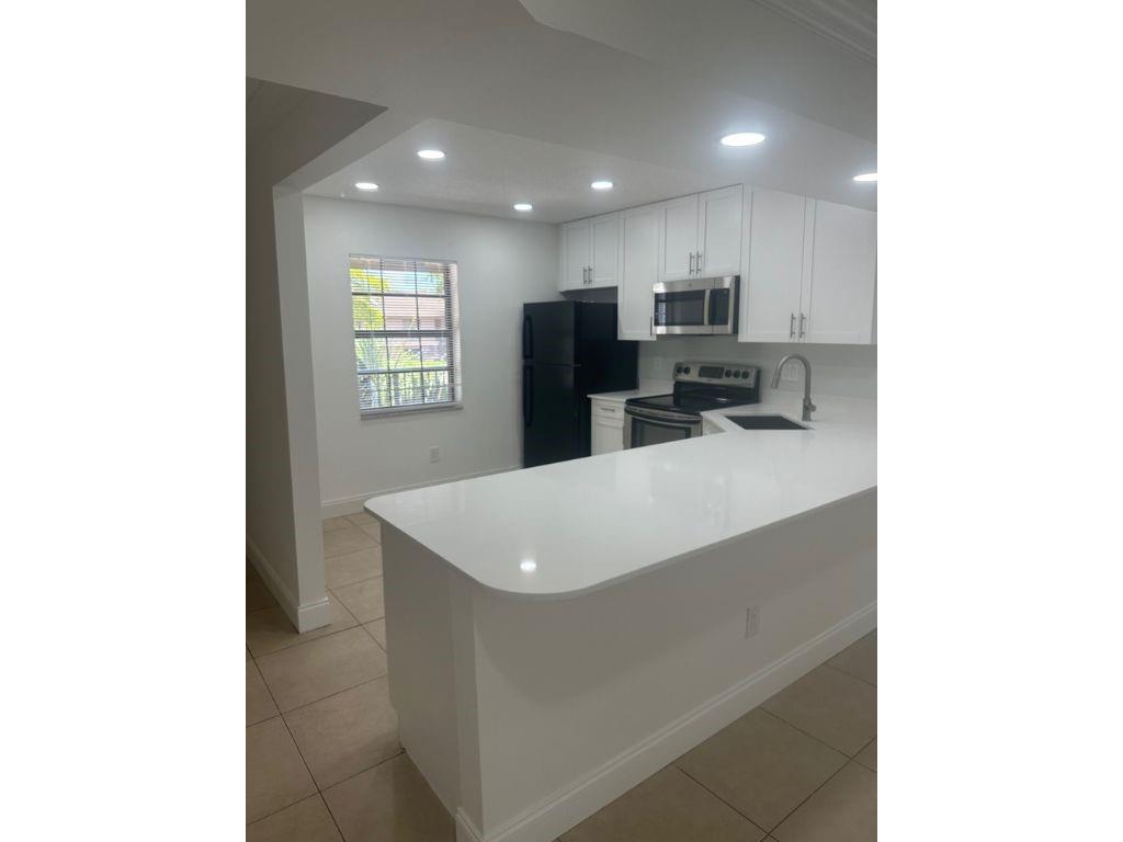 Totally updated apartment for lease; all ages, pet friendly. Quartz counters and stainless appliances, open kitchen and flowing layout. Serene garden and water view, washer and dryer in the unit. contemporary bath redo.