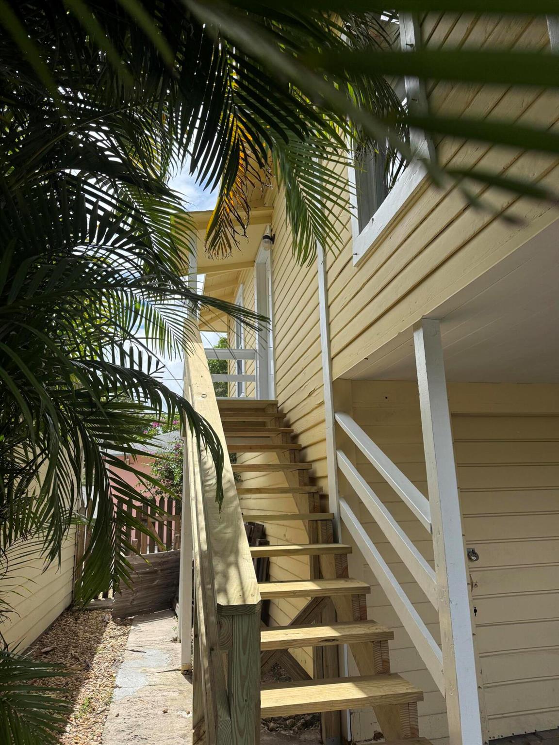 You'll love this bright, updated 2-bedroom, 1-bath upstairs apartment in the heart of downtown West Palm Beach! The remodeled kitchen has clean white cabinets, newer appliances, and hardwood floors, while the updated bathroom and in-unit stackable washer and dryer add extra convenience. Enjoy central A/C and a prime location close to Palm Beach Atlantic, City Paws Dog Park, CityPlace, and just a short walk to Clematis Street for dining and fun. This is the south upstairs unit, tucked privately behind the main house.