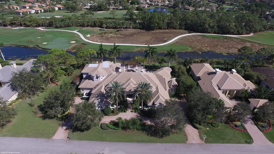 Stately 8,326 sq.ft., 5 bedroom, 61/2 bath custom estate home situated on a beautifully landscaped, nearly 3/4 of an acre lot. It literally will be love at first sight as you step onto the covered marble front entry, open the classic glass and mahogany doors and are greeted by 20 foot ceilings and picture windows that frame overwhelming golf course and water views. Impeccable decorating envelops you throughout with marble and hardwood flooring, custom draperies and motorized blinds, rich built-in wood cabinetry and crown moldings, hand painted, box beam and carved ceilings, marble backsplashes, granite counters, sophisticated decorator lighting, wainscoting, and a myriad of top-of-the-line conveniences.