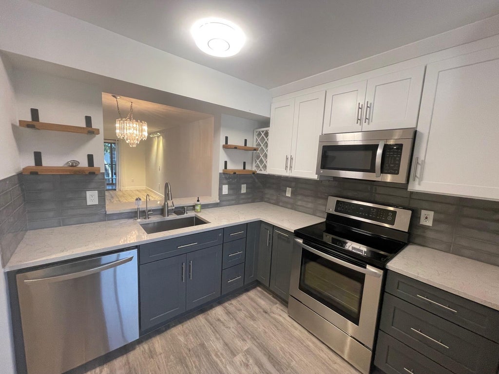 Photo of 6065 Pointe Regal Circle #301, Delray Beach, FL 33484 (MLS # B26089412)