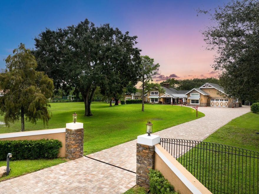 Experience true serenity in this custom, country chic, pristine estate on 3 well manicured acres in Parkland Ranches. The main home offers 3 bedrooms + Loft, 2 baths, soaring 20' pine ceilings, open floor plan, & two-sided fireplace. Chef's kitchen with white cabinetry, quartz counters, gas range & walk-in pantry. Wood plank porcelain tile throughout most of the home. Luxurious primary suite features a spacious bathroom and huge custom closet. Guest house includes 2 bedrooms, 1 bath, full kitchen, living and dining areas. Outdoors enjoy an enormous screened patio, heated pool with waterfall, travertine paths and a fish-stocked pond. Complete with impact windows & doors, whole home generator, 2 small stables and 3-car garage. A-rated schools, no HOA, close to equestrian center & dog park.