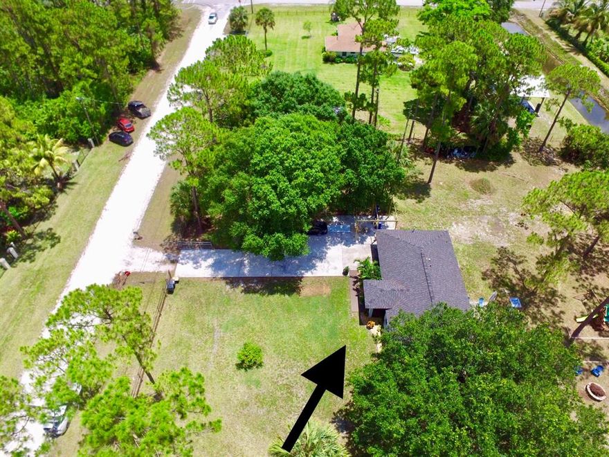 WHY RENT WHEN YOU CAN OWN THIS HOME !!!  BEST PRICED HOME IN ACREAGE/ WEST PALM BEACH !!  NEW ROOF 2019 !!!  3 BEDROOM 2 BATH 1 CAR GARAGE ON 1.29 ACRES !!!  NEW ROOF, NEW PAINT IN/ OUT.  RENOVATED BATH.  NEW FLOORING. STAINLESS APPLIANCES !! FULLY FENCED.  BONUS !!!  10,000 CAR LIFT FOR MECHANICS / OR   ANYONE NEEDING TO LIFT HEAVY EQUIPMENT !!  BONUS !! LOCATED CLOSER TO NORTH LAKE FOR EASY ACCESS TO HIGHWAY, SHOPPING.  MINUTES TO BEACH, AIRPORT, SCHOOLS, BANKS, LIBRARY.  CANAL IN BACK OF HOUSE- NO REAR NEIGHBORS.  NO HOA- BRING YOUR RV, BOAT, TRAILER OR HORSES.  HUGE YARD SPACE  FOR THE KIDS TO  RUN AROUND ENJOY THE OUT DOORS.  KIDS PLAY SET STAYS.   ROOM FOR POOL !!  ENJOY THE EVENING SUNSET  / BAR B QUE WITH FRIENDS AND FAMILY IN THE BACK PAVER PATIO.  LOTS OF PRIVACY !!   NO HOA