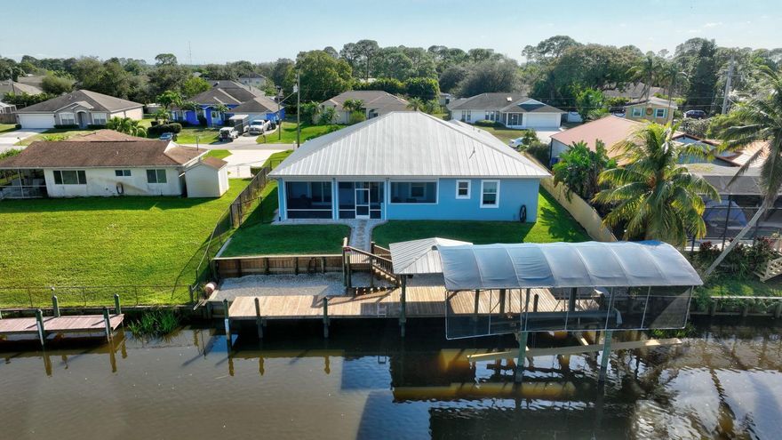Experience new luxury living with this 2019-built waterfront home featuring direct ocean-access, a private dock, and boat lift right in your backyard. Enjoy stunning, unobstructed water views, an open, pride-of-ownership interior, 4 bedrooms, 3 baths, and a versatile flex space. Highlights include a center-island kitchen, spacious patio with outdoor kitchen, big green egg smoker,grill, fridge & more.  The Covered dock, covered boat lift, fish station, w/ H2O, and electric complete the perfect back yart.  smart outlets/switches, 8 smart TVs, Luma camera system, oversized garage with cabinets, propane appliances, and RV 50-amp outlet. All this in a great location close to shopping, restaurants and still a great ride to the ocean.