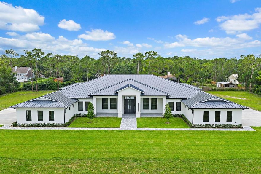 Brand-new 2025 luxury estate on 2.5 acres in Jupiter Farms. Offering 8,230 sq ft of living space + guest house, 6 bedrooms, 8 full & 2 half baths, and over 10,900 total sq ft under roof. Built with uncompromising quality: steel-reinforced CBS construction, impact glass, charcoal metal roof, and foam insulation. Interiors feature 48x48 marble-look tile, soaring 10-16 ft ceilings, custom closets, and level 5 finishes. Gourmet kitchen with dual refrigerators, double ovens, pot filler, wet bar, and 10' cabinetry. Resort-style pool with 6,250 sq ft marble deck, summer kitchen, sauna, gym, billiards, media room, and wine cellar. Guest house with full kitchen & living. Horses permitted, no HOA. A rare opportunity for modern luxury on acreage in Jupiter. Brand-new 2025 luxury estate on 2.5 acres in Jupiter Farms. With over 8,200 sq ft of living space (10,900+ total), this one-of-a-kind property delivers both scale and sophistication.

Inside, soaring 10-16 ft ceilings, 48"x48" porcelain tile, and 8' solid-core doors set a refined tone. The gourmet kitchen is a showpiece: dual Samsung bespoke refrigerators, two ranges, pot filler, 10' cabinetry, quartz counters, and a walk-in pantryanchored by a wet bar with wine fridge and ice maker. Flex spaces abound: media room, gym with sauna, executive office, billiards/family lounge, and even a dedicated dog wash. Each of the 5 ensuite bedrooms offers marble bathrooms and custom closets; the primary suite features dual walk-ins, a spa-style shower, and freestanding tub.

A self-contained 1-bedroom guest house with its own entrance, kitchen, laundry, and living room makes this property ideal for multigenerational living, extended guests, or private work quarters.

Outdoor living rivals a resort: heated saltwater pool & spa, 6,250 sq ft marble pool deck, full summer kitchen, and a 14' covered patio for entertaining. A 4-car garage, 7,500 sq ft driveway, and 2,000 sq ft of paver walkways provide ample parking and function.

Practical features include foam insulation, Daikin high-SEER AC units, Rheem water heaters, full impact glass, reverse-osmosis water system, and ethernet wiring in 12 locations. Horses and RVs welcomeno HOA.

All of this just minutes from A-rated schools, Riverbend Park, shopping, dining, and Jupiter's beaches.

Luxury, lifestyle, and acreage freedom12850 152nd Street N is Jupiter Farms at its absolute best.