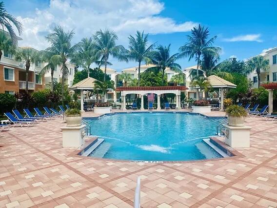 Beautifully updated 2-bedroom, 2-bathroom condo featuring a charming sunroom. This upgraded unit is move-in ready, boasting pristine finishes throughout. Fiore at the Gardens is a tranquil, gated community offering an array of resort-style amenities, including a gym, heated pool, car wash, putting green, and more. The community's excellent location adds to its appeal.