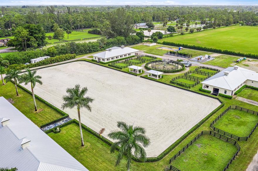 Remarkable 10 acre equestrian property located in Loxahatchee Groves, across from Binks Forest. Great potential for income producing property with a total of 38 stalls and room for temporary tented stalls. Main barn built in 2012 consists of 18 stalls, tack room, feed room, lounge with refrigerator and sink, bathroom and laundry room, fully matted aisles, fly spray system, rolling doors at each entrance. Two smaller barns with 10 stalls each, tack room, flies spray system, feed room with rolling door for easy hay and grain drop off, a 1/2 bath and separate stackable washer/dryer... built in 2016. Each of the two smaller barns have one bedroom grooms quarters with a full kitchen and washer/dryer). Property Features a round pen, two Wordley Martin riding arenas (Supplemental Remarks)...