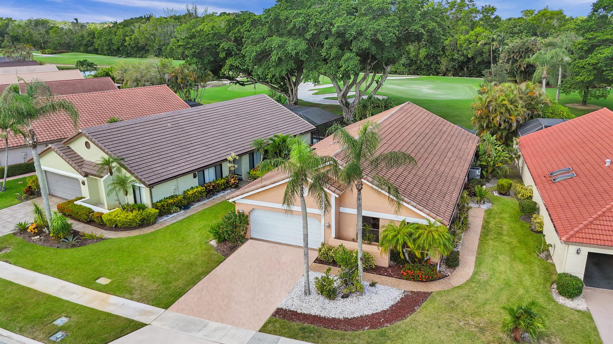 Come see this lovely three bedroom, two bathroom home in the all-age community of Boca Woods Country Club. From the moment you enter, you will feel the space and openness...there are cathedral ceilings in the main living area and the kitchen wall has been taken down - the island makes entertaining so easy. Stainless steel appliances and plenty of cabinets. The kitchen and bathrooms were renovated several years ago and they still look great. You will love the amazing primary bathroom with the added linen closet. For continuity, ceramic tile has been used throughout the house. The washer and dryer area has been enclosed and a laundry room was created where there is also an extra refrigerator. And there are no rear neighbors - just a beautiful view of the 6th green of the Lakes course.