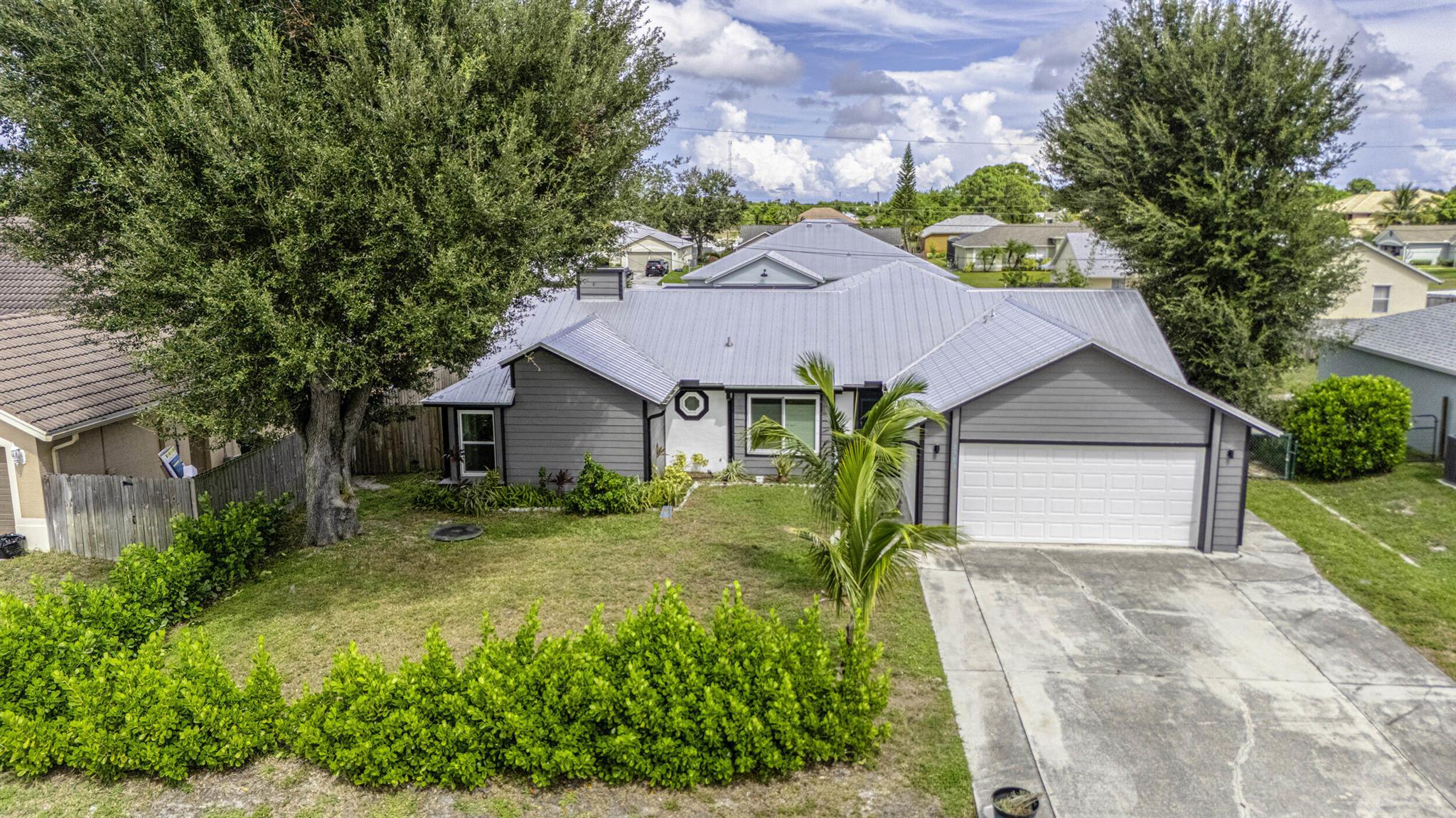 Beautiful 4-bedroom, 3-bath pool home in Port St. Lucie featuring a metal roof, hurricane impact windows, and a screened saltwater pool. The main residence offers 3 bedrooms and 2 baths for $3,200/month, with the option to include a private 1-bedroom, 1-bath mother-in-law suite and office for an additional $800/month. Pool and lawn care are included in the rent, offering hassle-free living. Flexible options make this home ideal for multi-generational living or work-from-home needs. Conveniently located near shopping, dining, and major roadways. Pets considered.